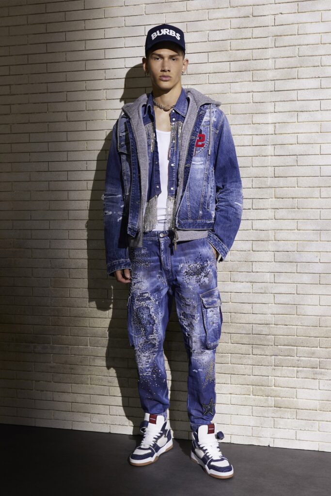 An oversized blue denim jacket paired with matching denim pants featuring unique embellishments.