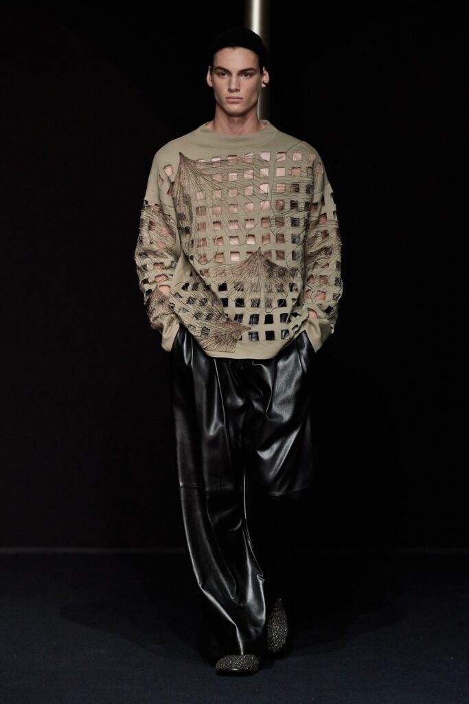 beige cutout top and black leather pants