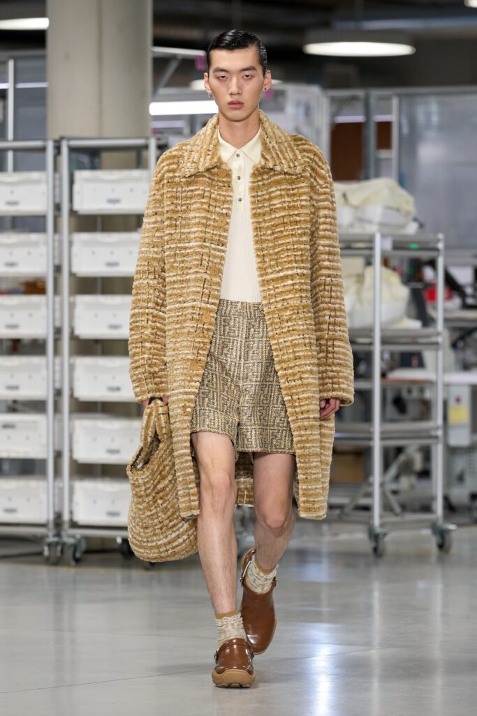 A relaxed brown fur coat paired with beige cotton shorts featuring a collared neckline.