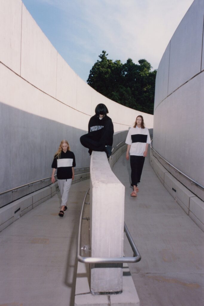 A relaxed black and white color-blocked top paired with comfortable pants.