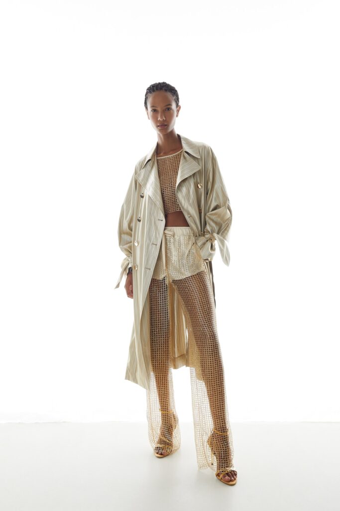 beige silk trench coat with gold mesh top and pants