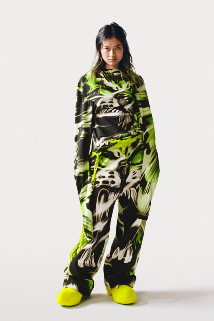 An oversized green and black printed top paired with matching pants for a bold streetwear look.