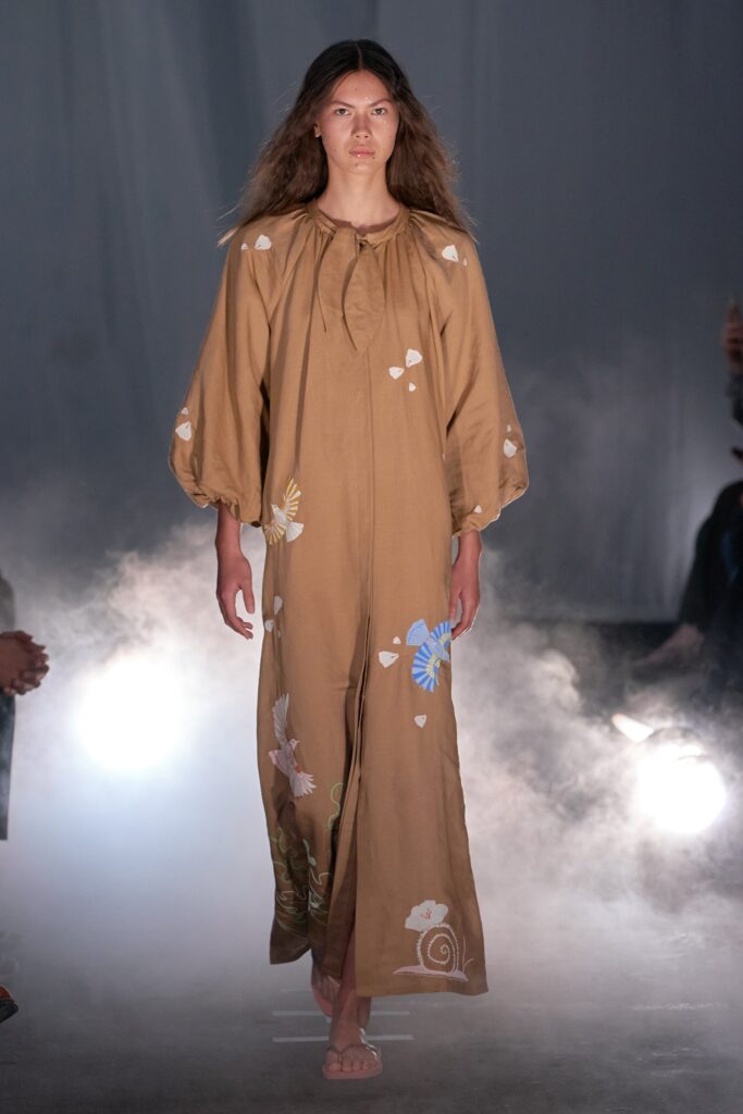A relaxed brown cotton dress with long sleeves and embroidered floral details.