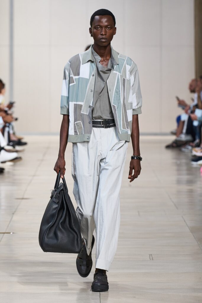 A relaxed gray cotton short-sleeve shirt paired with wide-leg white pants.