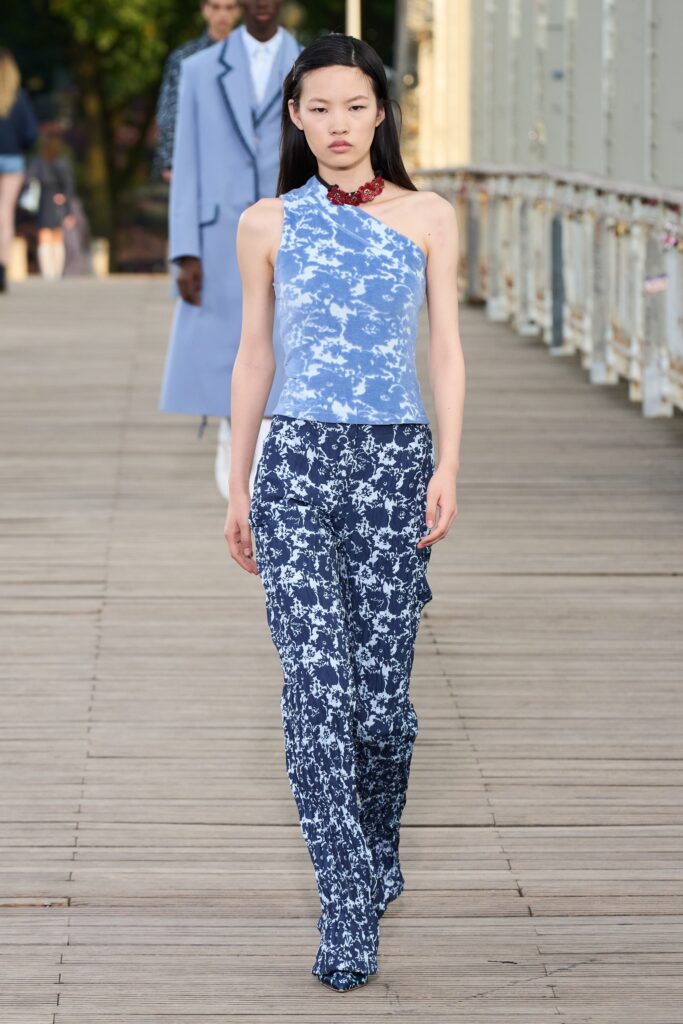 A fitted blue printed sleeveless top paired with matching fitted pants.