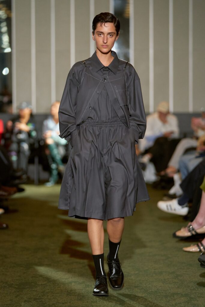 A relaxed gray cotton dress with long sleeves and pleated detailing.