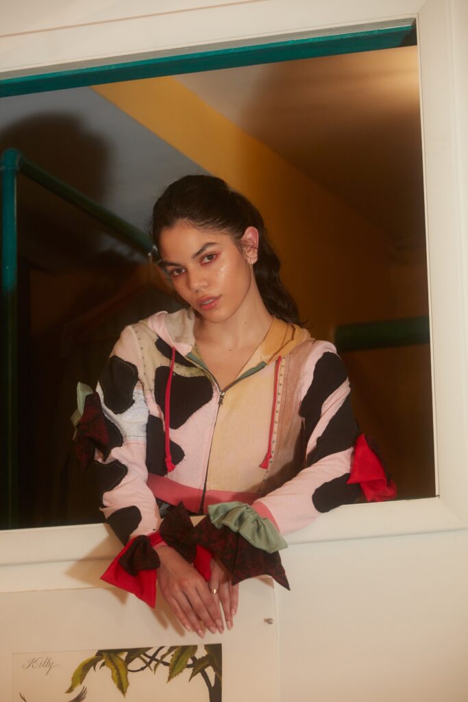 A relaxed multicolor hoodie with long sleeves and a hood, featuring a color-blocked design.