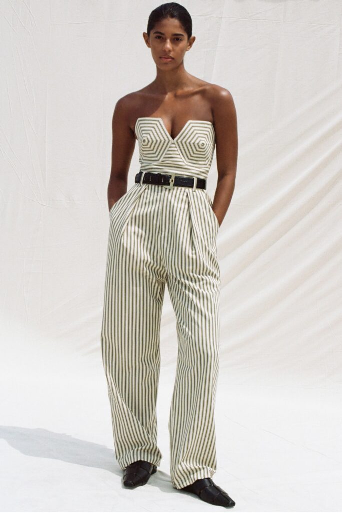 A fitted striped jumpsuit with a strapless design and V-neckline.