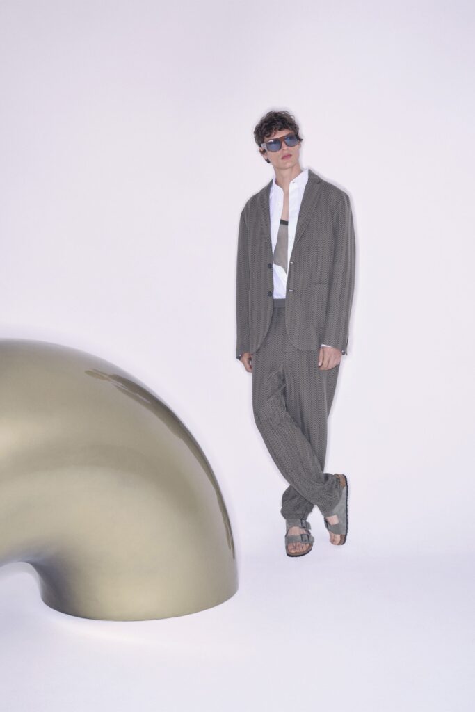 A tailored gray striped suit with a collared shirt and long sleeves.
