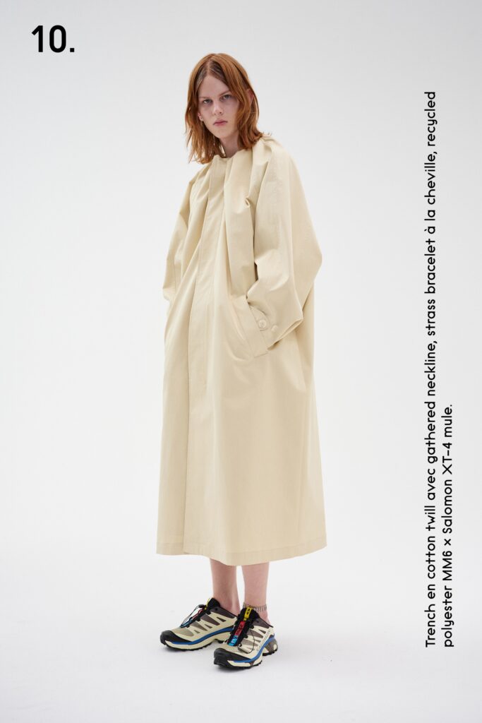 A relaxed beige cotton dress with long sleeves and a collared neckline.