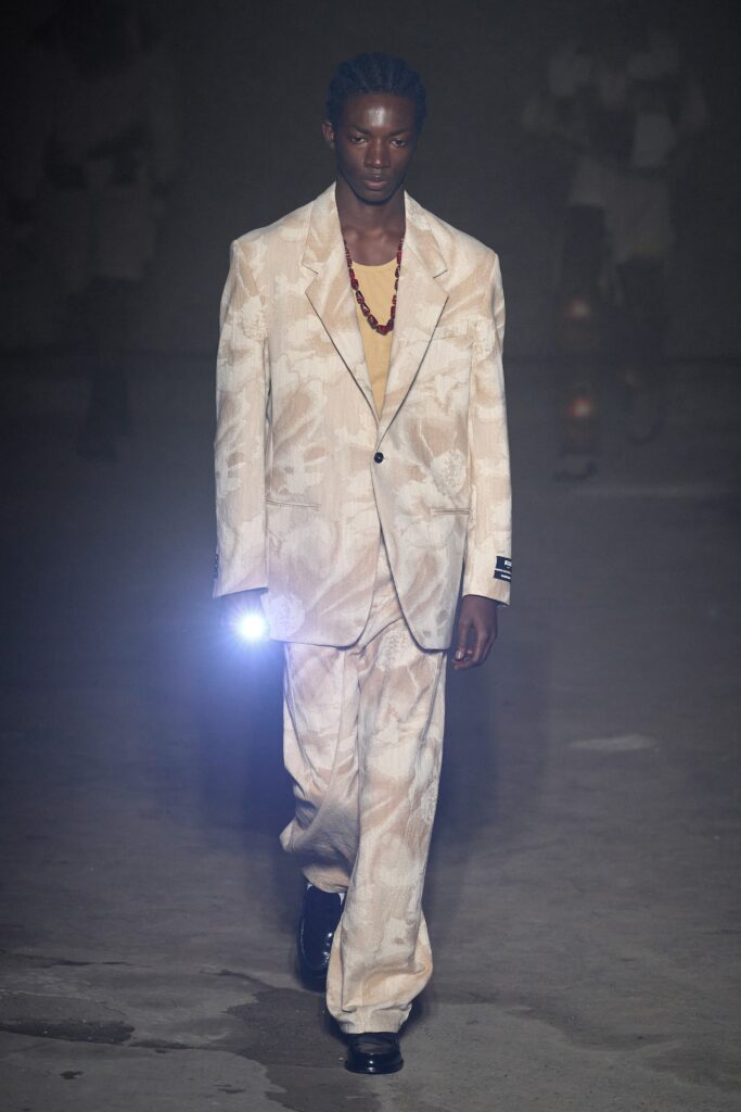 A relaxed beige printed suit featuring a collared long-sleeve shirt.