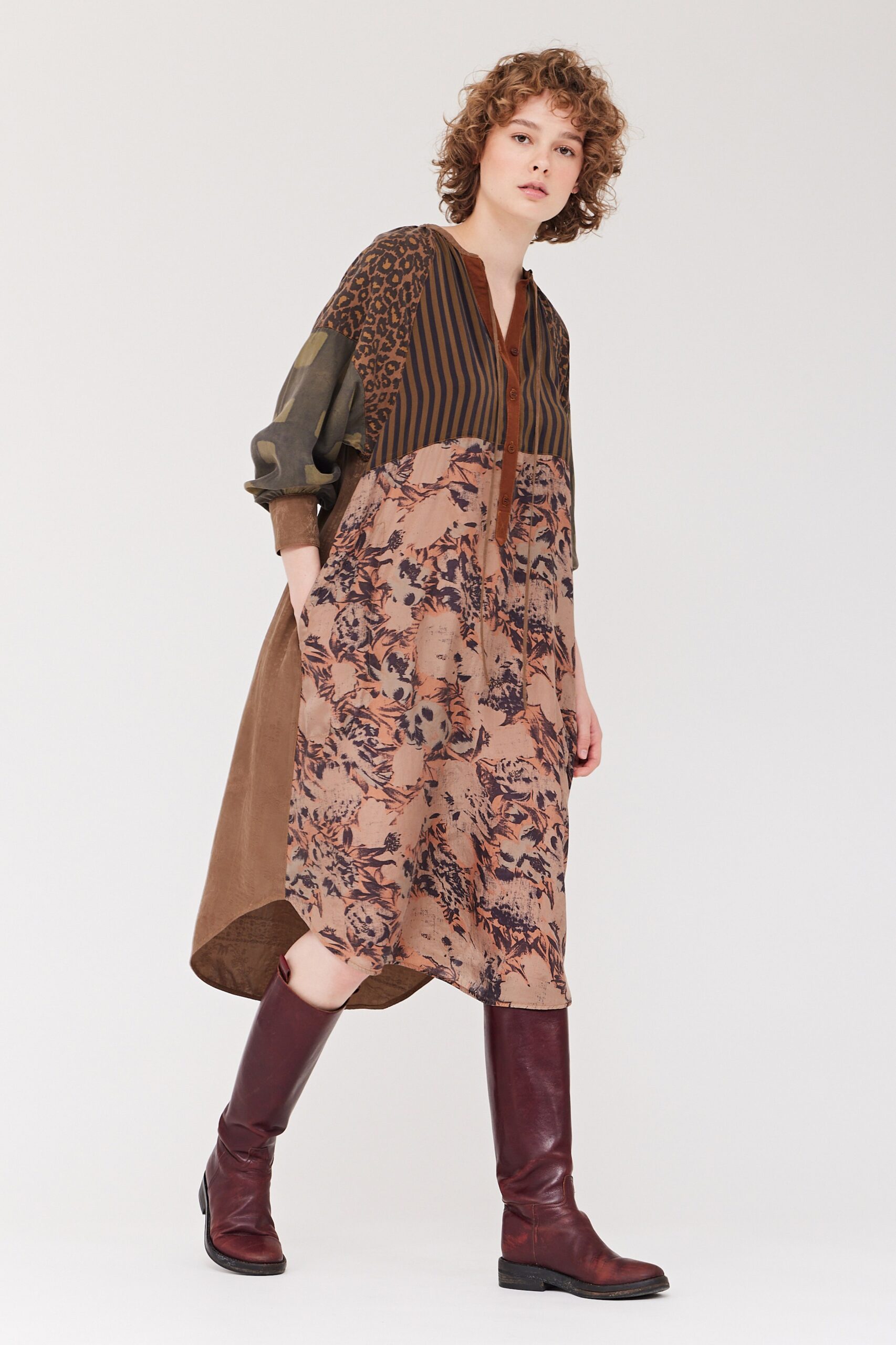 A relaxed multicolor dress with long sleeves, a collared neckline, and an asymmetric silhouette.