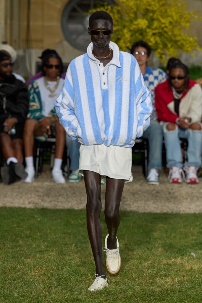 A relaxed blue and white striped long-sleeve top paired with shorts.