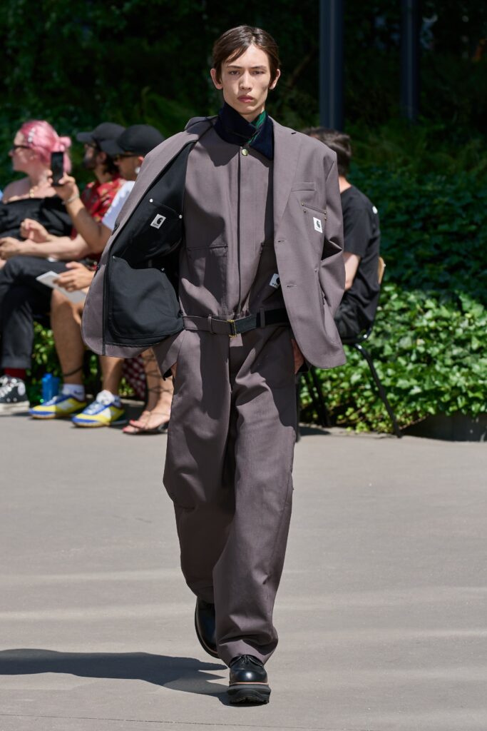 A relaxed gray suit with long sleeves and a collared design, featuring buttoned details.