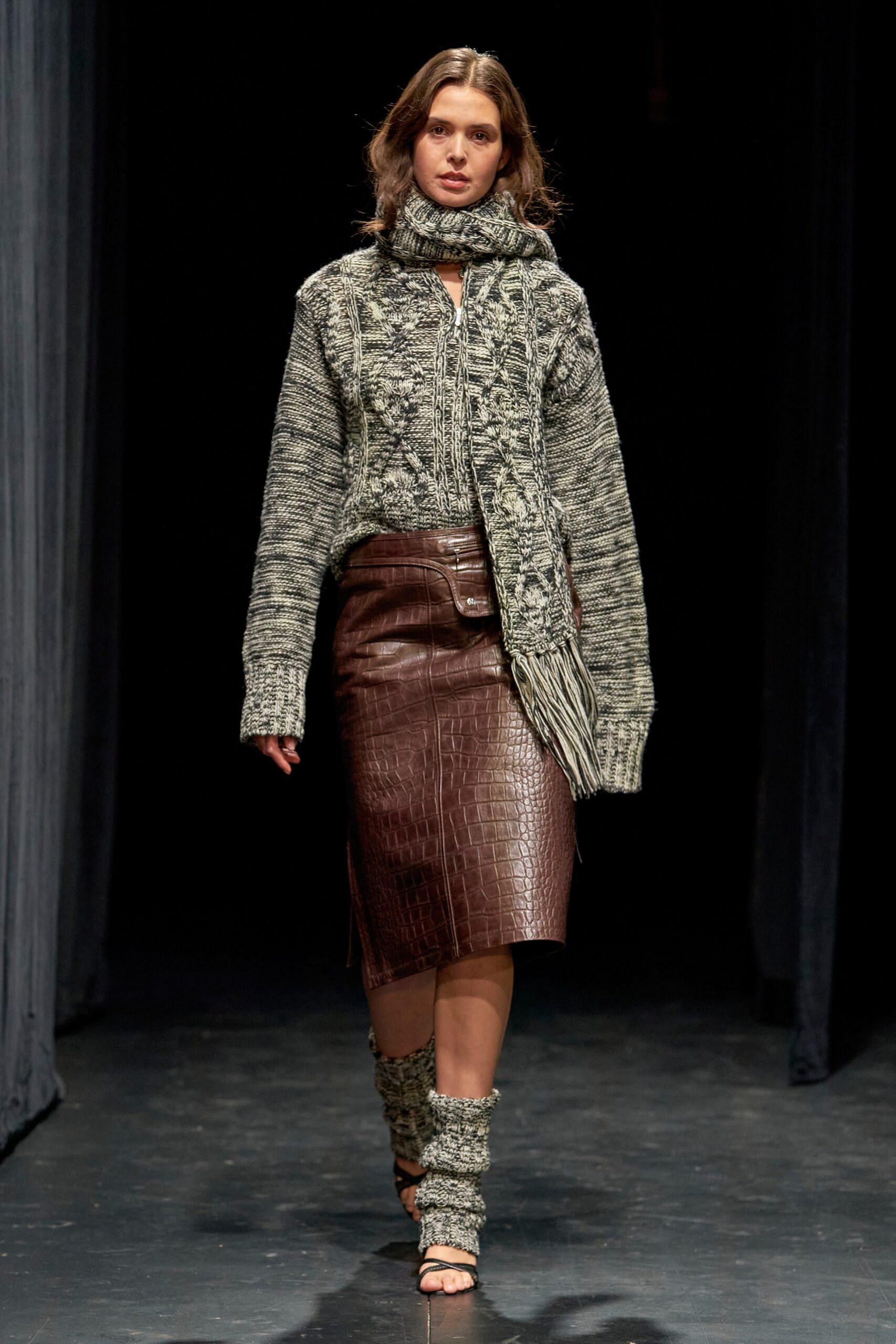 A fitted gray wool long-sleeve sweater paired with a high-waisted brown leather pencil skirt.