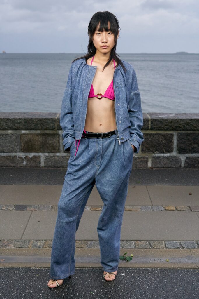 A relaxed blue denim jacket with long sleeves and wide-leg pants.