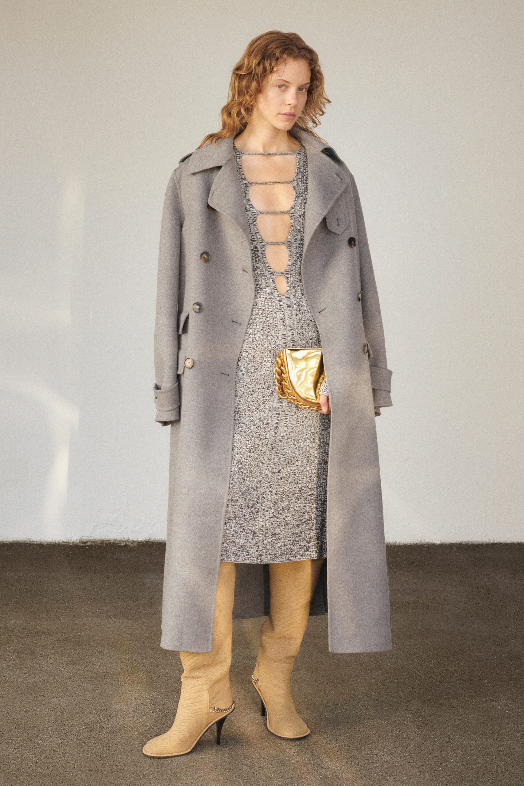 A fitted gray wool dress with a long-sleeve coat featuring a buttoned design.