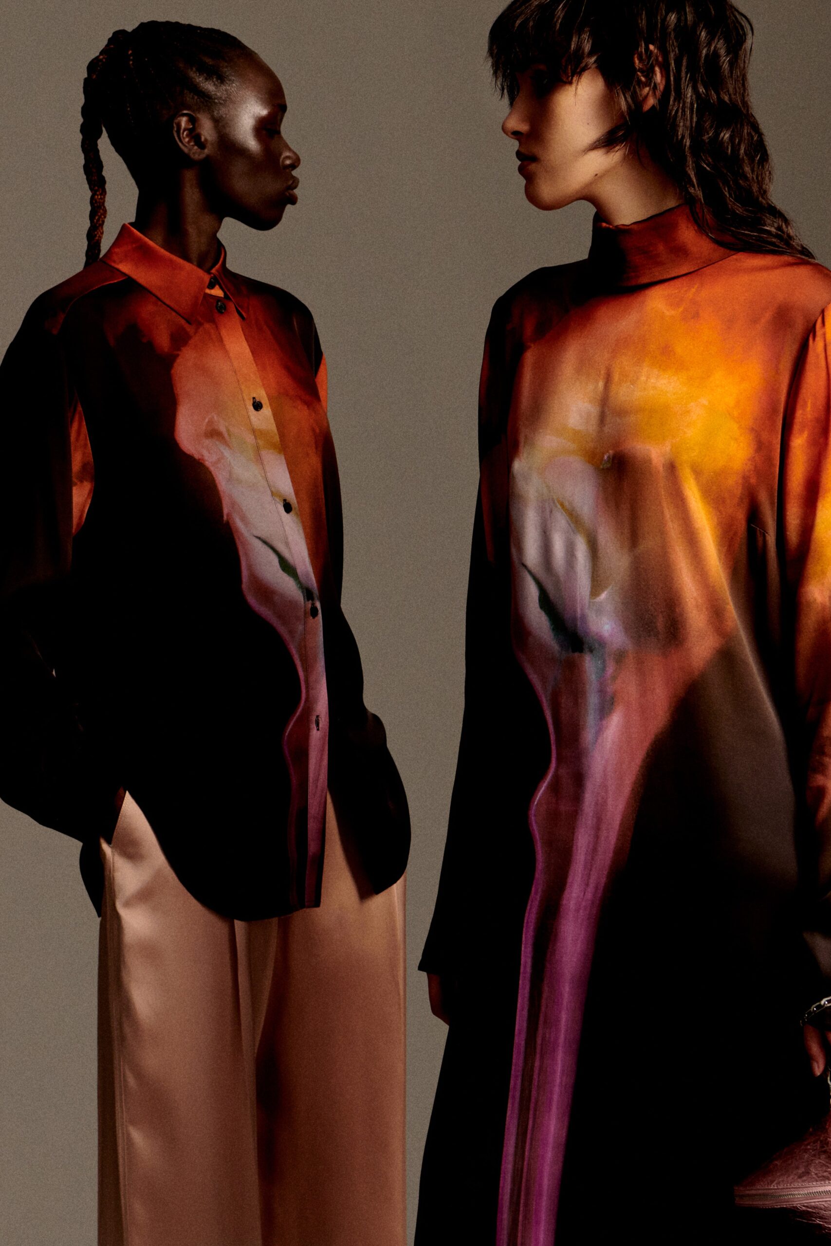 printed black silk shirt and beige pants