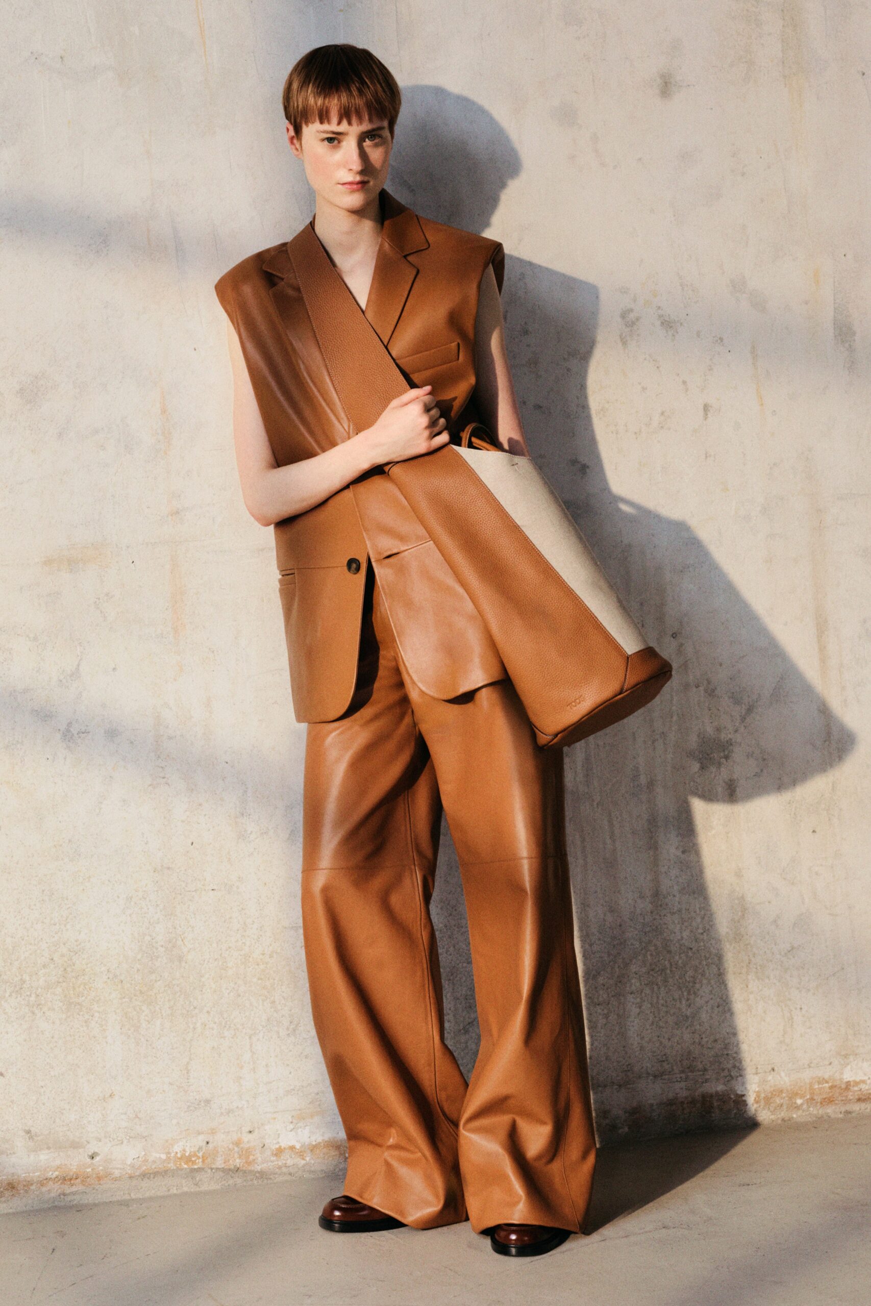 brown leather sleeveless blazer and wide-leg pants