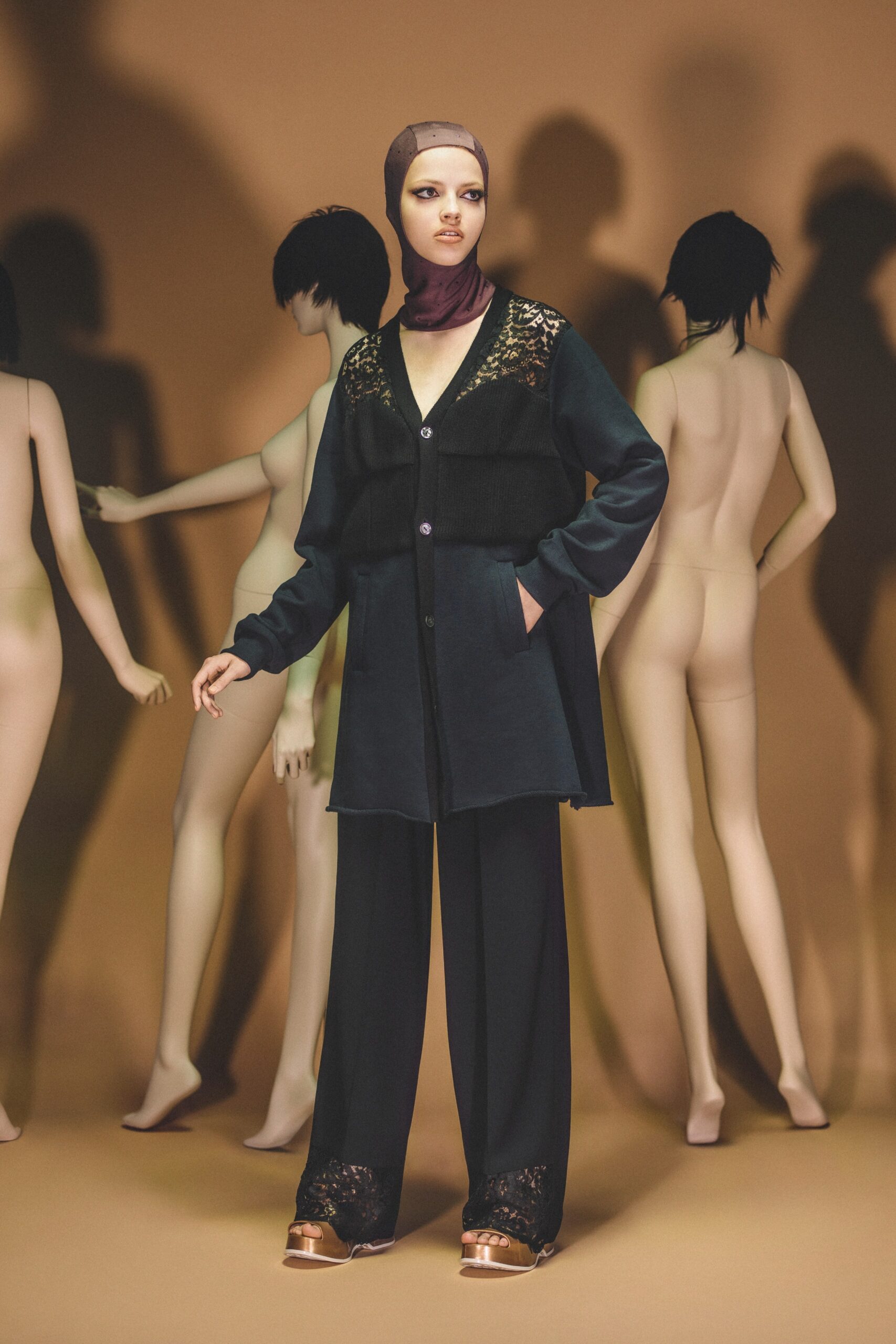 A relaxed black jacket with long sleeves and a collared design, paired with matching pants.