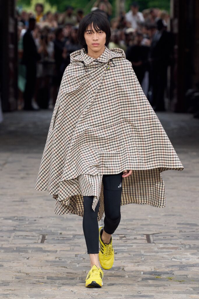 An oversized beige and brown checked poncho with a collared design.