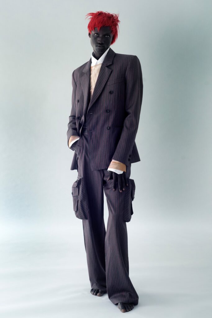 A tailored gray striped suit with long sleeves and a collared shirt.
