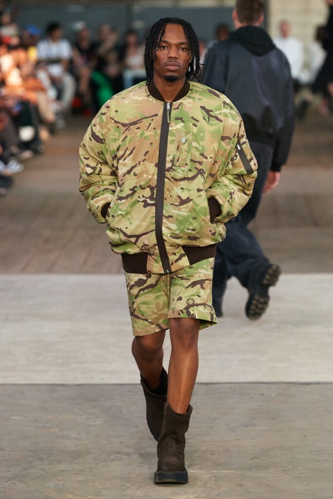 A relaxed fit green camouflage jacket paired with matching shorts for a stylish streetwear look.