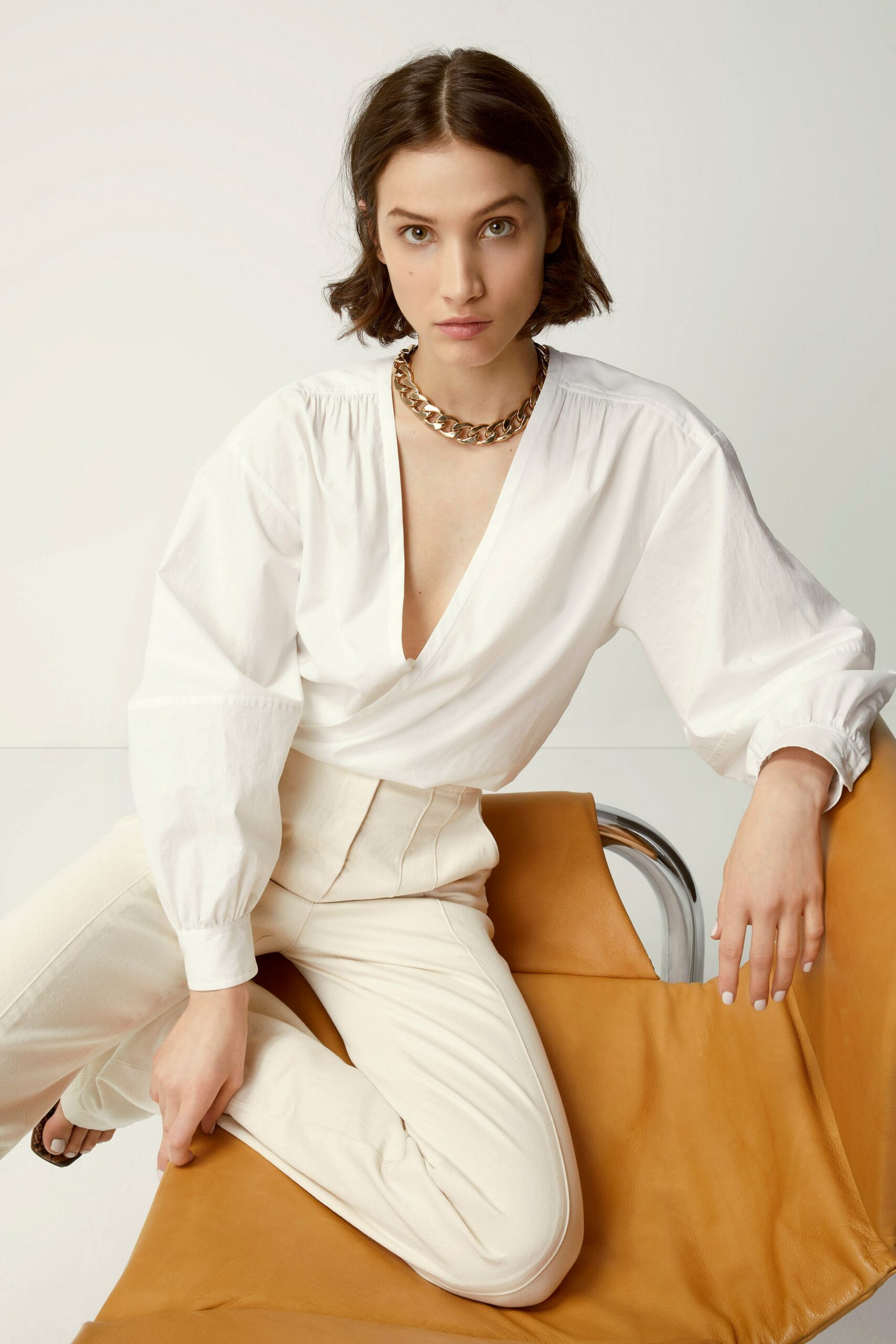 white cotton long-sleeve v-neck fitted blouse