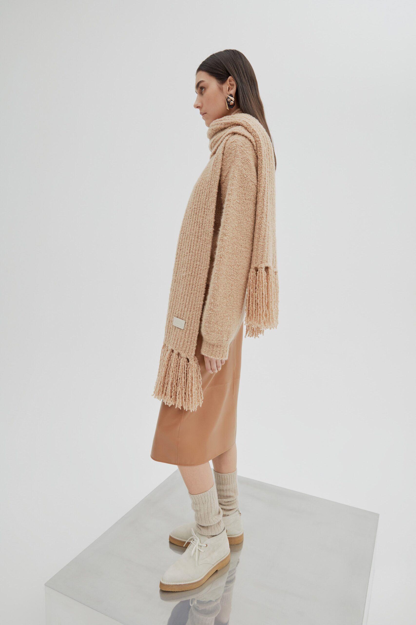 beige wool sweater with brown leather skirt