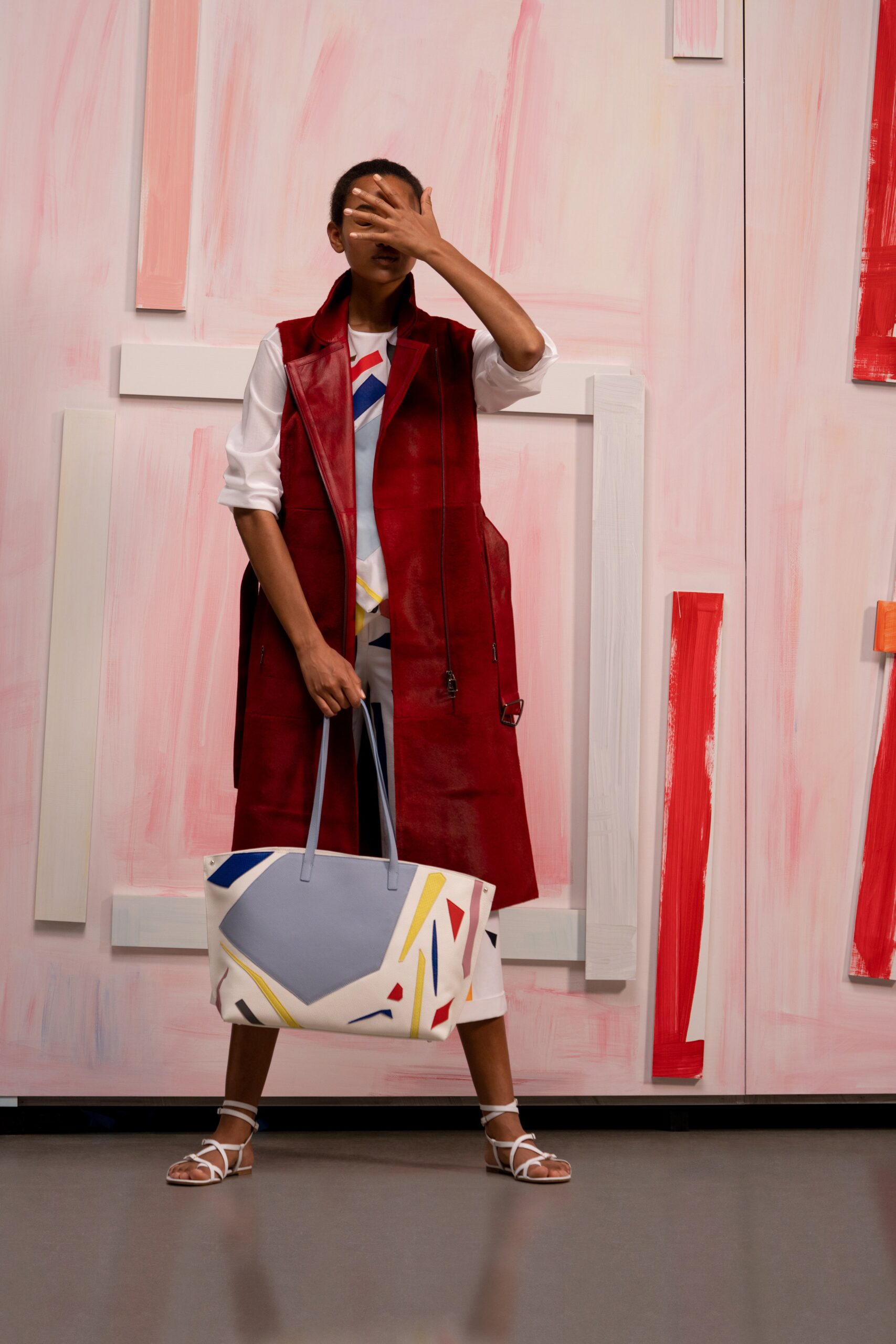red leather sleeveless coat and white dress