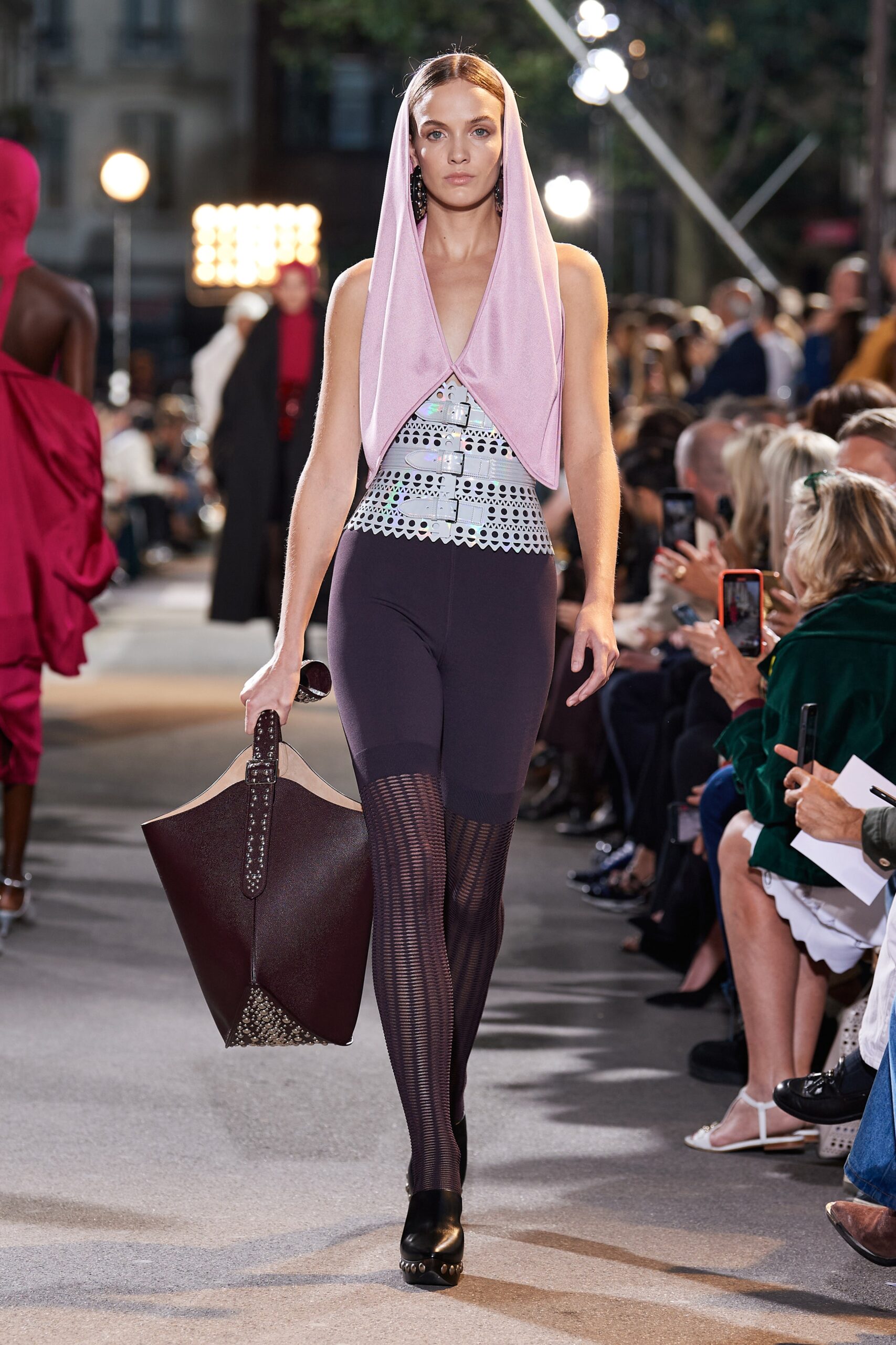 pink high-neck fitted top with black pants