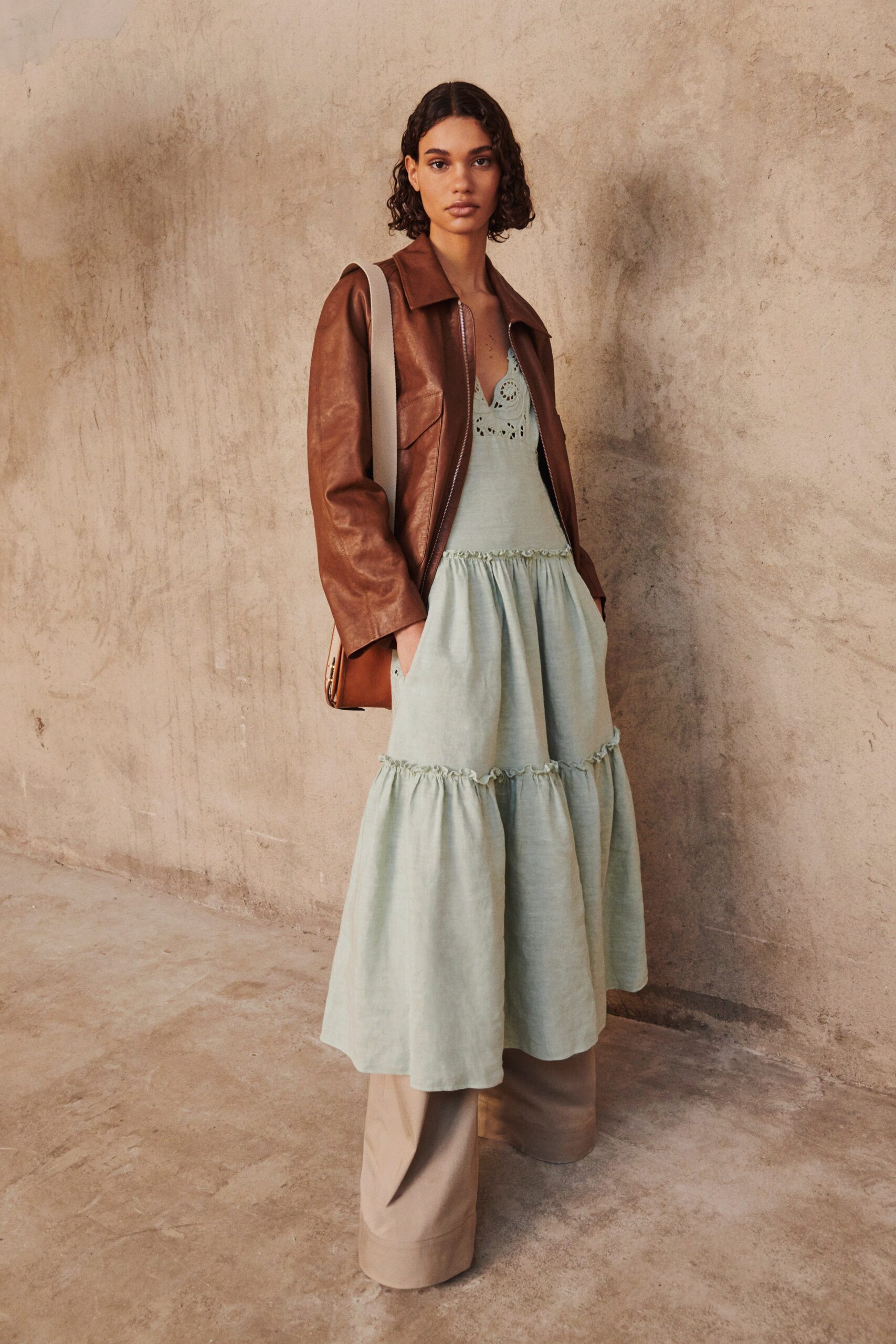 green tiered maxi dress with brown leather jacket
