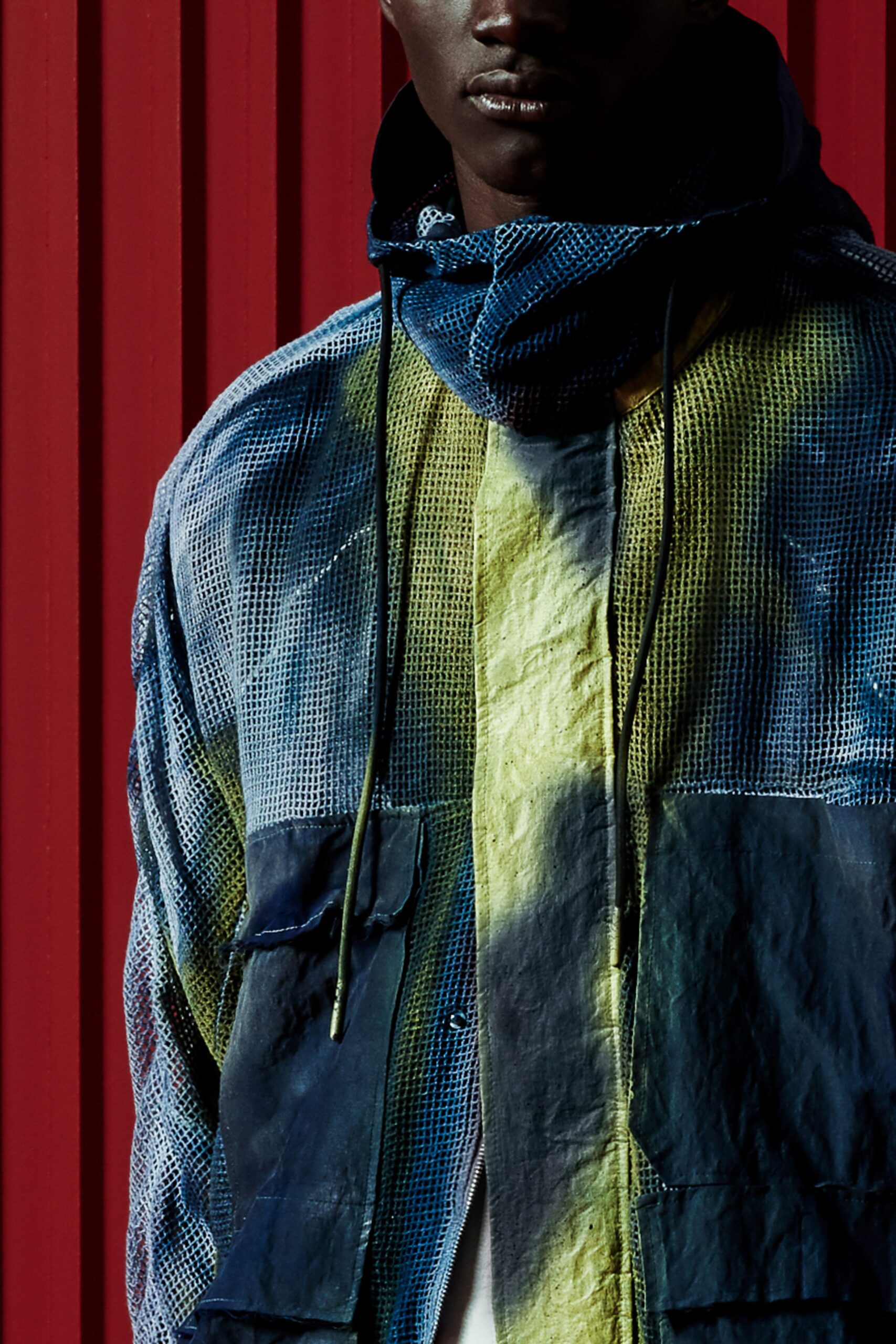 A relaxed blue and yellow cotton jacket with a hood and long sleeves featuring a color-blocked design.