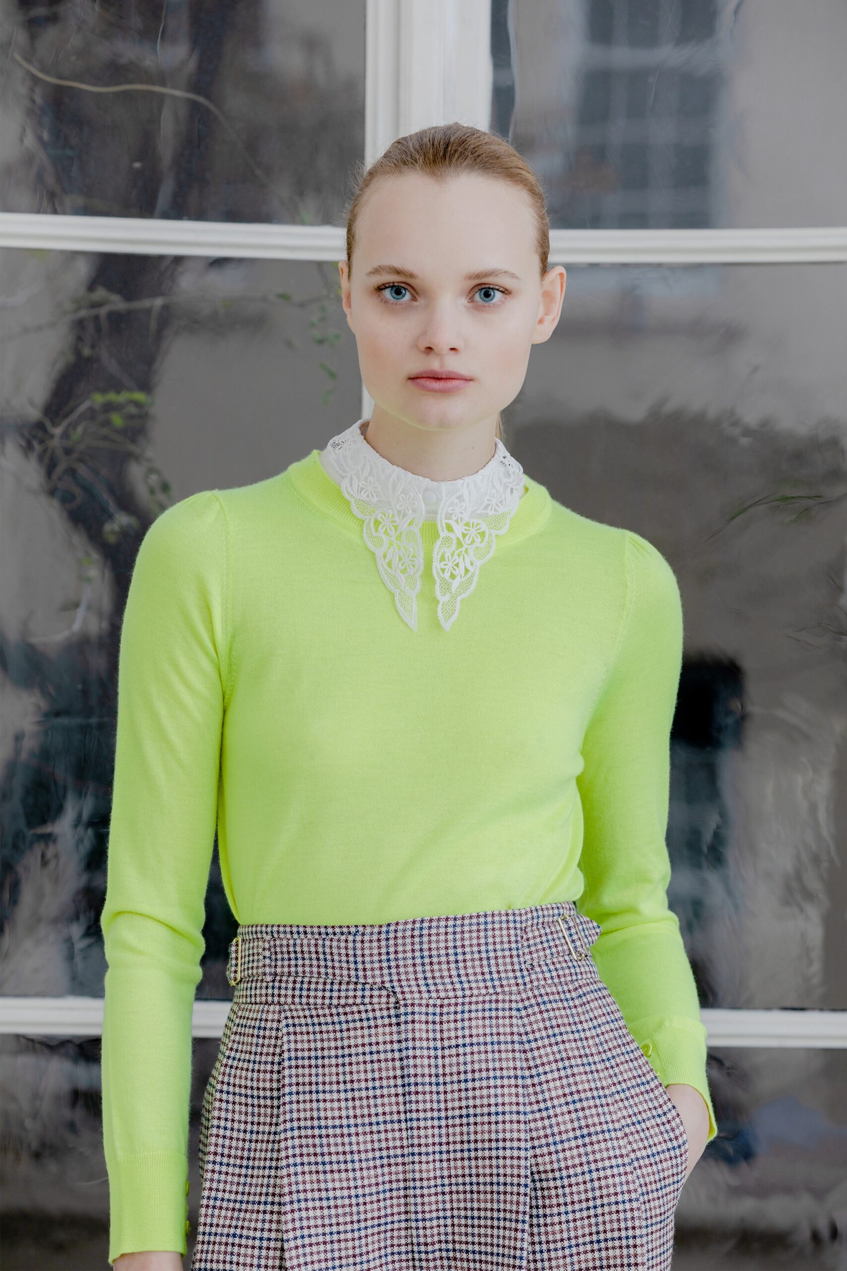 neon green fitted sweater and tailored pants