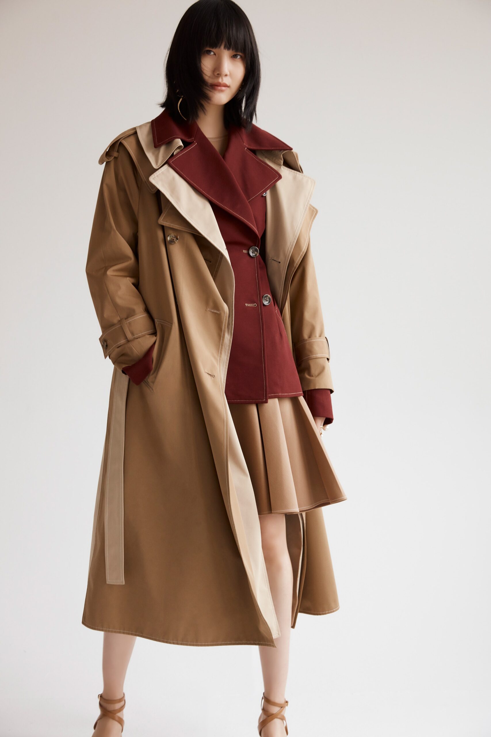 beige trench coat with red blazer
