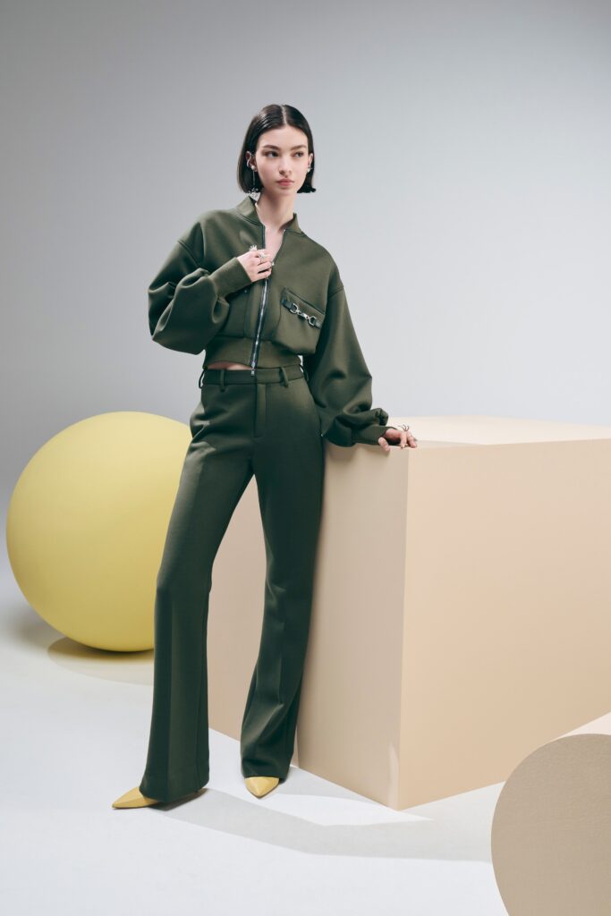 A relaxed green jacket with a zippered front paired with matching pants.