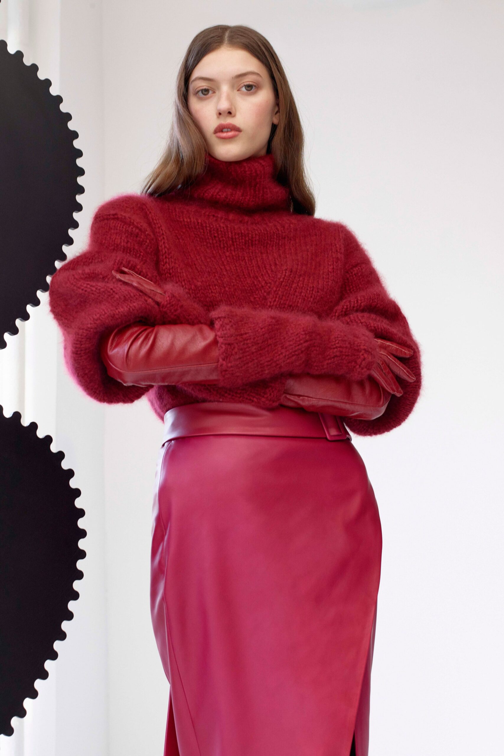 red wool relaxed sweater and pink leather midi skirt