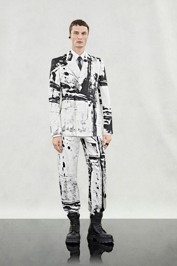 A fitted black and white printed suit with a collared long-sleeve shirt.