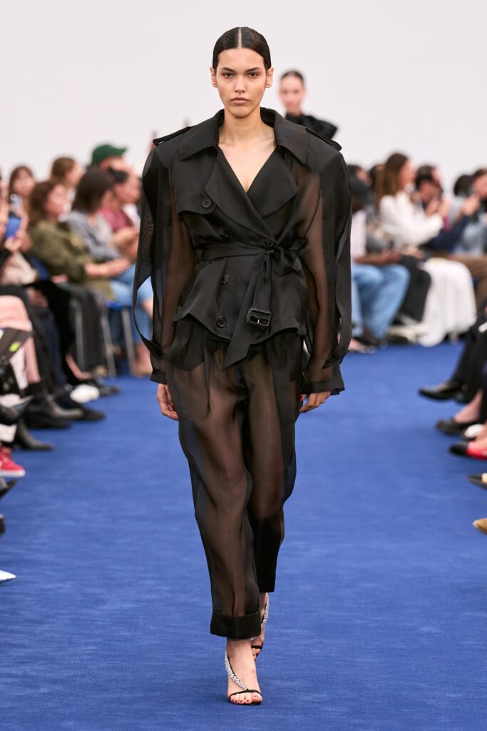 A relaxed black sheer jacket with long sleeves and matching pants featuring a layered design.