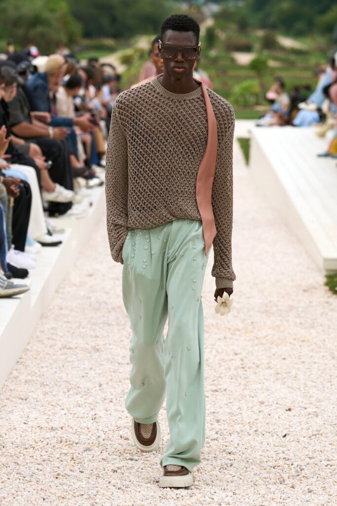 A relaxed brown cotton long-sleeve sweater paired with light green pants featuring a layered design.