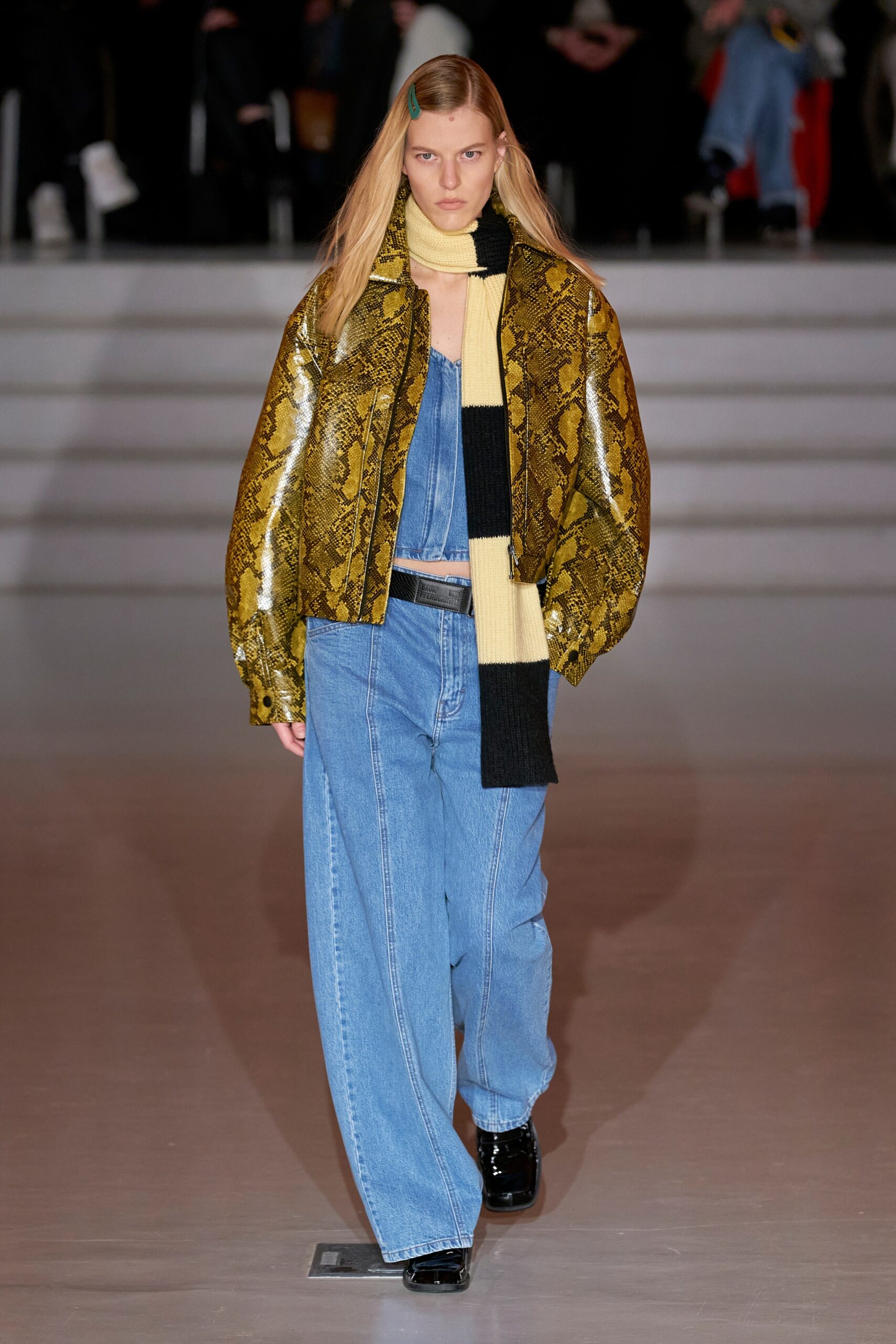yellow vinyl printed jacket and blue denim pants