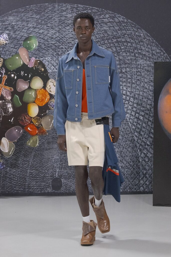 A relaxed blue denim jacket paired with white cotton shorts, featuring a collared design.