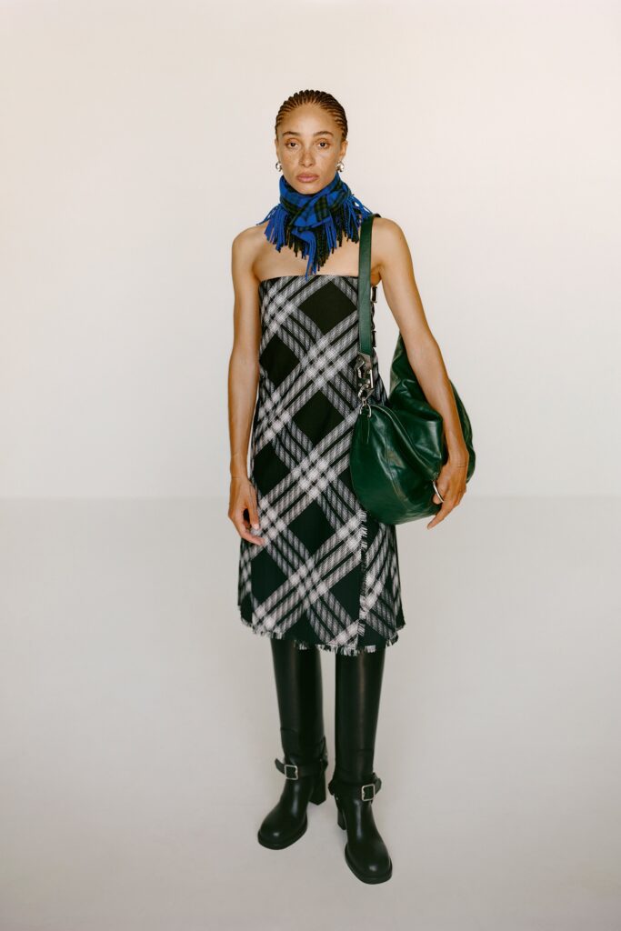 A fitted sleeveless black and white checked dress featuring a V-neckline.