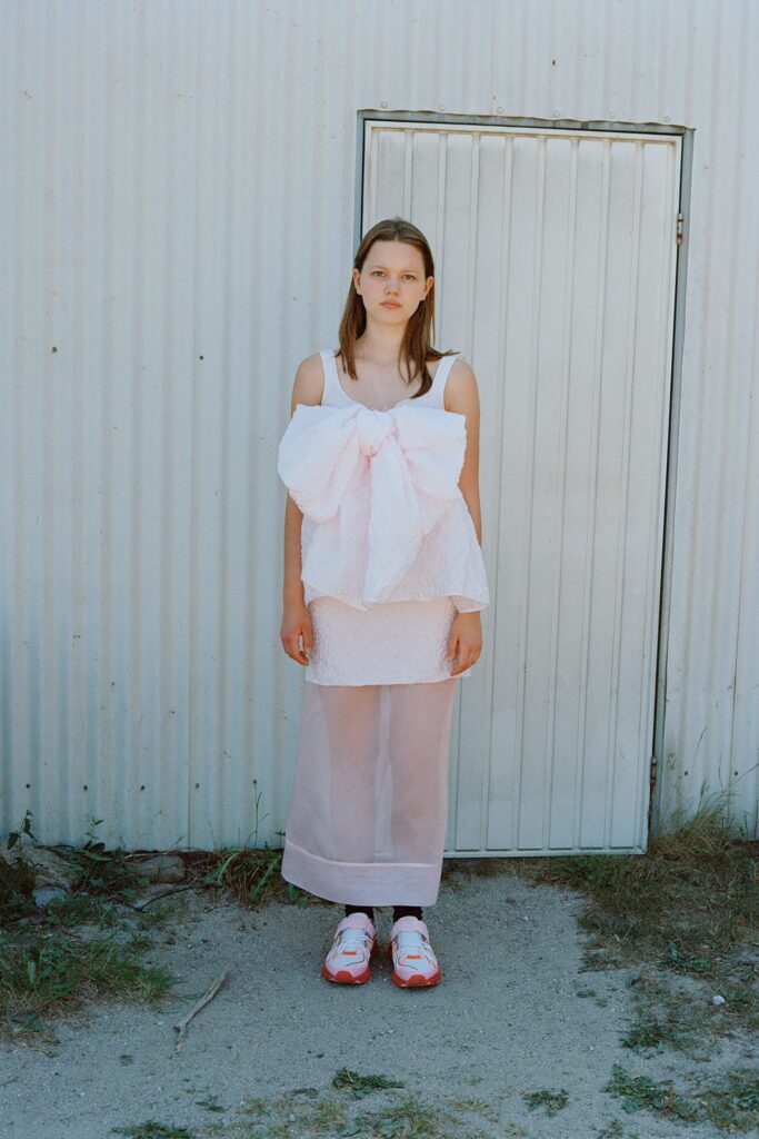 A relaxed pink cotton sleeveless top with a layered design paired with a matching skirt.