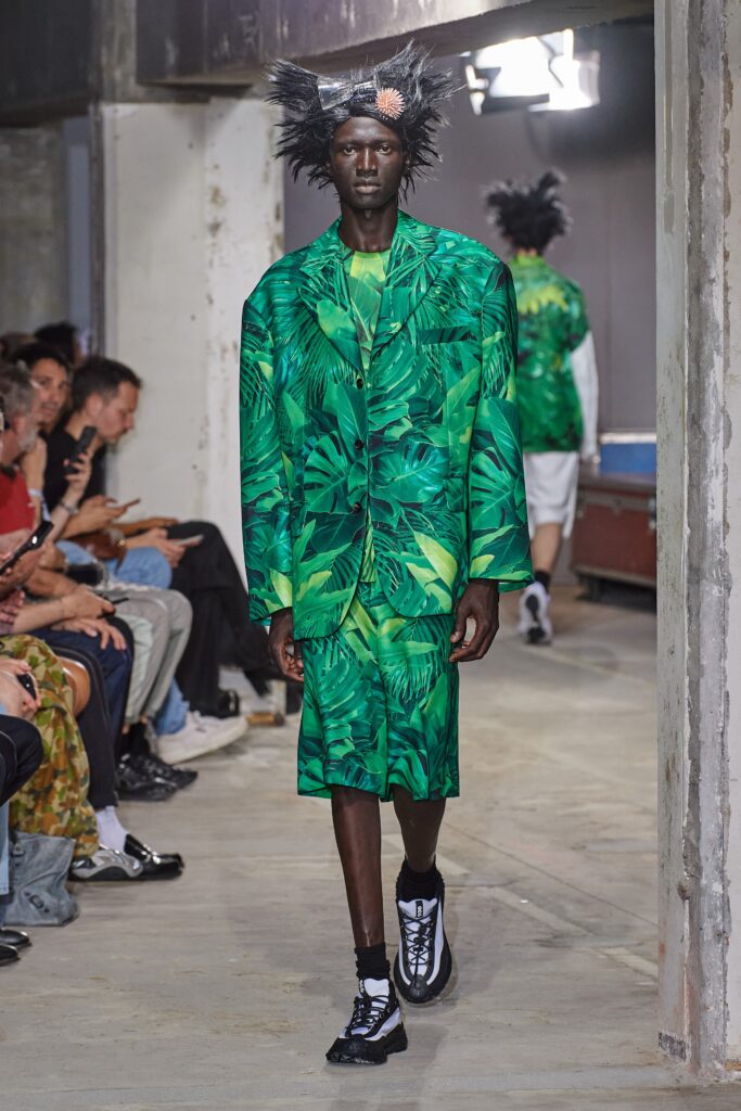 A relaxed green cotton suit with a collared short-sleeve design featuring a vibrant print.