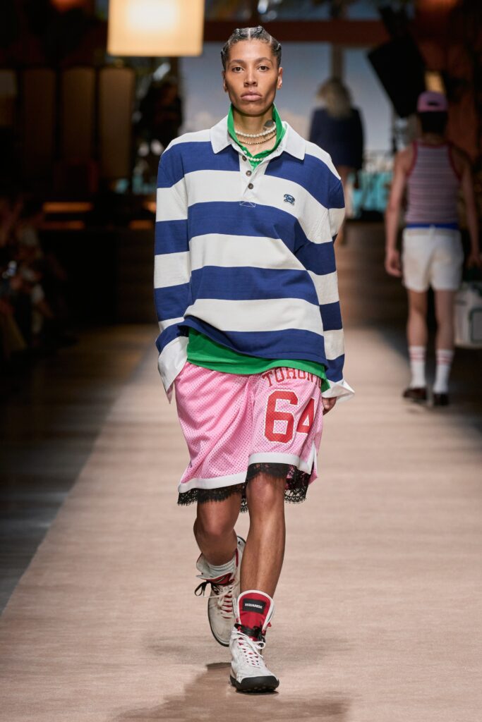 A relaxed blue and white striped long-sleeve shirt paired with printed pink shorts.