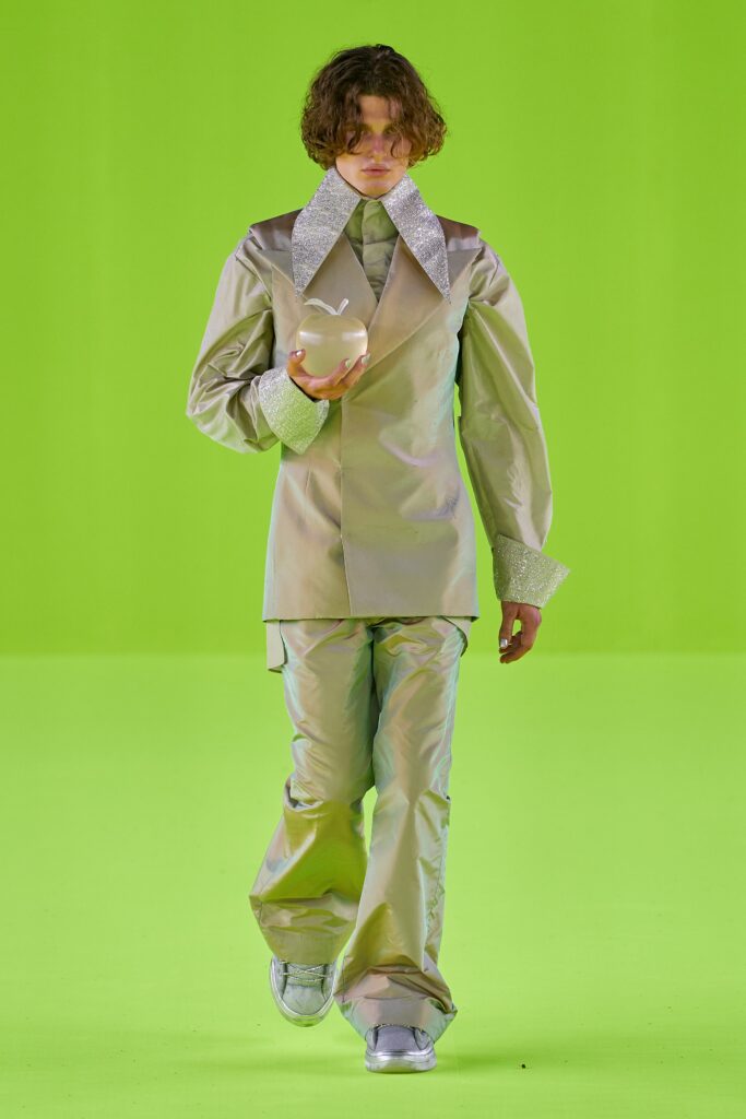 A relaxed silver satin jacket with long sleeves and wide-leg pants.