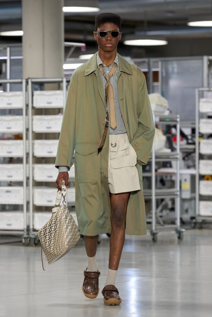 A relaxed beige coat paired with shorts, featuring a collared long-sleeve design.