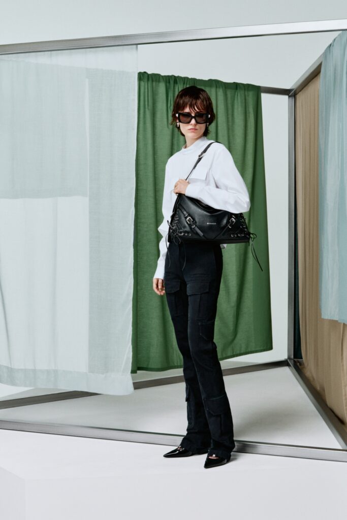A fitted white long-sleeve collared shirt paired with straight-leg black pants.