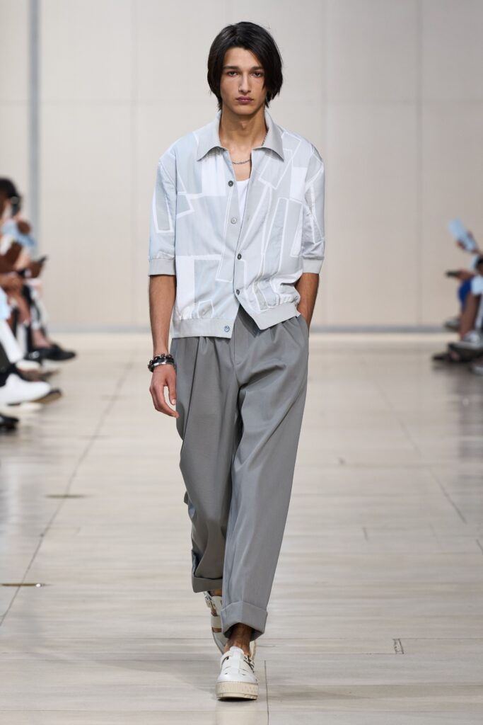 A relaxed white cotton short-sleeve shirt paired with wide-leg gray pants.